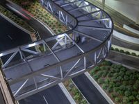 a view of a road and an overpass with traffic passing through it by buildings