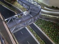 a view of a road and an overpass with traffic passing through it by buildings