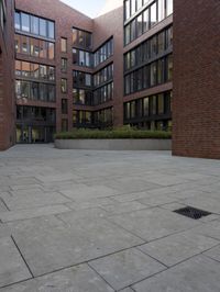 an empty floor in front of brick building with glass windows with an open patio to the side