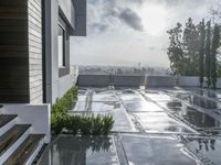 a view of the outside patio of an apartment building with tile floors and a bench