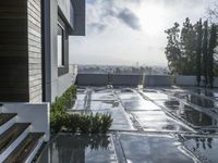 a view of the outside patio of an apartment building with tile floors and a bench