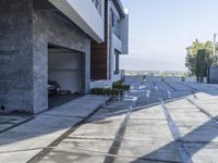 the exterior and landscape of a modern house in los angeles, california with stone and wood