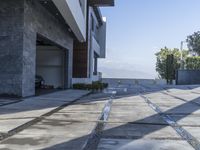 the exterior and landscape of a modern house in los angeles, california with stone and wood