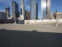 a parking lot with buildings in the background and sunlight reflecting off it's windows