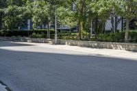 a car driving down an empty street lined with tall buildings and trees in the background