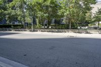 a car driving down an empty street lined with tall buildings and trees in the background