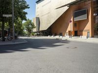 the large building has windows and many trees in front of it at the entrance to the museum