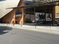 the large building has windows and many trees in front of it at the entrance to the museum