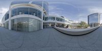 a 360 - view photo of a courtyard, including two buildings and a staircase in the middle