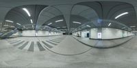 the inside of an airport building, with a large circular mirror above the ground and some stairs to the left