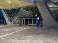 the entrance to an airport with stairs leading up to it and a large glass wall