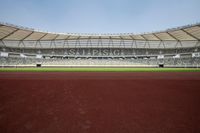 a view of an empty stadium with people inside it and an empty sports field with a lot of seating