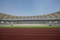 a view of an empty stadium with people inside it and an empty sports field with a lot of seating