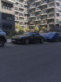 three cars are parked in front of an apartment complex in a city street with high rise buildings