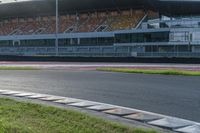 a motorcyclist rides a race car around the track at an outdoor track