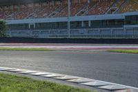 a motorcyclist rides a race car around the track at an outdoor track