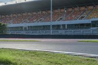 a motorcyclist rides a race car around the track at an outdoor track