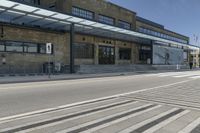 the outside of a building with a big canopy above it with stairs leading to the side