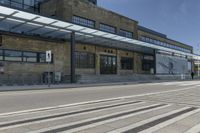 the outside of a building with a big canopy above it with stairs leading to the side