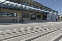 the outside of a building with a big canopy above it with stairs leading to the side