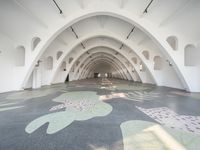 an art - filled hall with arches and animal designs on the floor and floor tiles