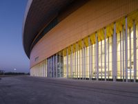 a photo of the architecture of an auditorium at dusk, looking very elegant and well lit