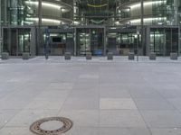 an office building with a metal door leading out to a large space for people to walk through