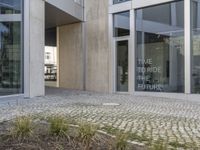 entrance to the building, showing several steps up into the room and a person on the street