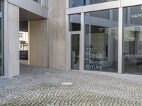 entrance to the building, showing several steps up into the room and a person on the street