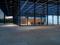 a large indoor event area with chairs and a table outside the entrance of an office building