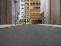 the side walk is empty and ready to be used as a walking path between buildings