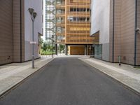 the side walk is empty and ready to be used as a walking path between buildings