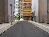 the side walk is empty and ready to be used as a walking path between buildings