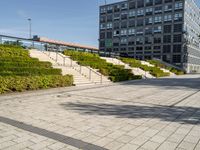 a man riding on top of a skateboard on a stone road near tall buildings