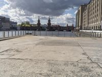 a person sitting on a bench looking out at the water with a bridge in front of it