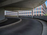 a car is driving on the highway through an underground parking garage area in a city