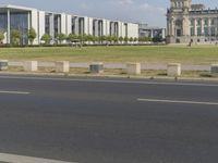 a young man rides his bike past the parliament building in berlin, germany by himself