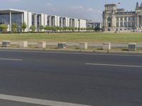 a young man rides his bike past the parliament building in berlin, germany by himself