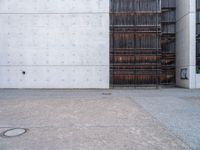 a large open space outside on concrete and steel building material that looks like wood and is lined with black, white, red and brown stripes