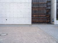 a large open space outside on concrete and steel building material that looks like wood and is lined with black, white, red and brown stripes