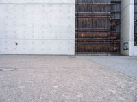 a large open space outside on concrete and steel building material that looks like wood and is lined with black, white, red and brown stripes