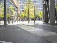 empty walkway in an outdoor area, with people walking along the side walk and on the sidewalk