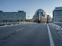 two roads in front of a large building with lots of windows on either side of it