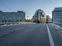 two roads in front of a large building with lots of windows on either side of it