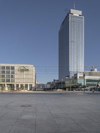 a very tall office building with a clock tower in it's center of a city square