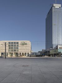 a very tall office building with a clock tower in it's center of a city square