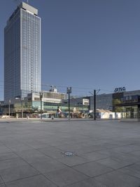 a very tall office building with a clock tower in it's center of a city square