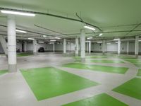 an indoor parking lot with green and white flooring and a payphone in the middle of the photo