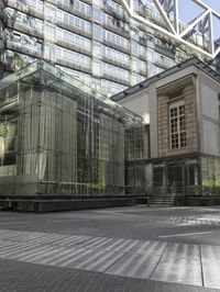 large building with a metal and glass structure on one side and large windows on the other