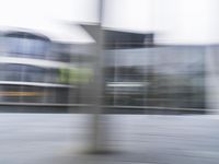 a blurry image of a man riding a skateboard on the road using motion blurred